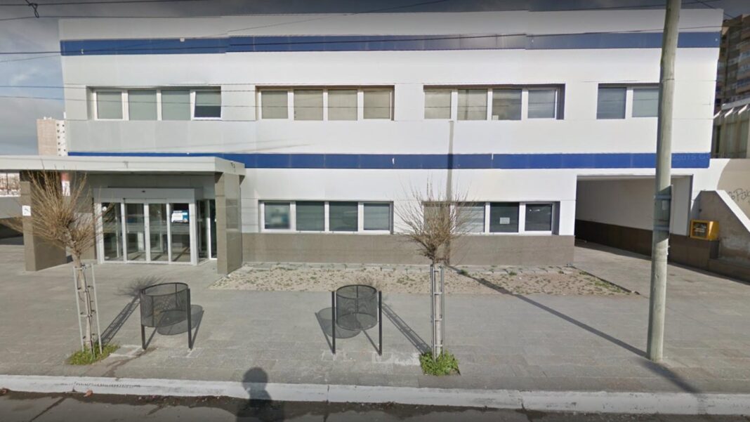 Ilustración de una balanza de la justicia frente a una casa, representando un fallo judicial sobre vivienda en Puerto Madryn.